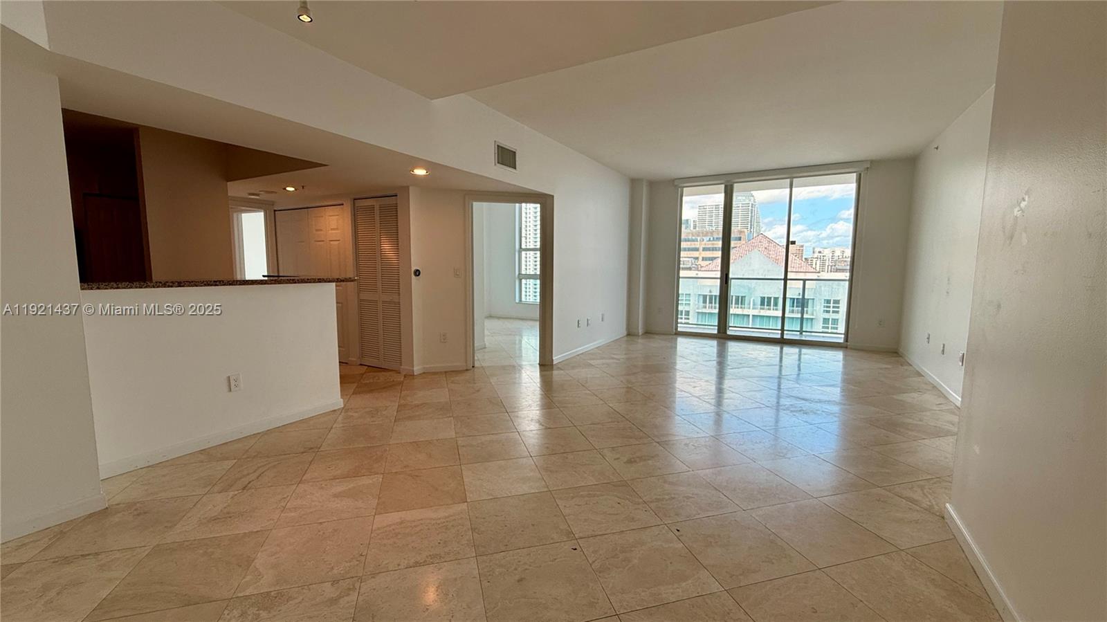 1155 Brickell Bay Drive, Unit PH104 Miami, FL 33131 - Photo 2 of 35 wooden floor in an empty room with a window