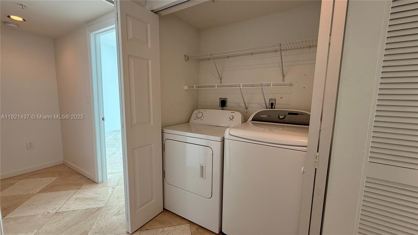 1155 Brickell Bay Drive, Unit PH104 Miami, FL 33131 - Photo 24 of 35 a utility room with dryer and washer
