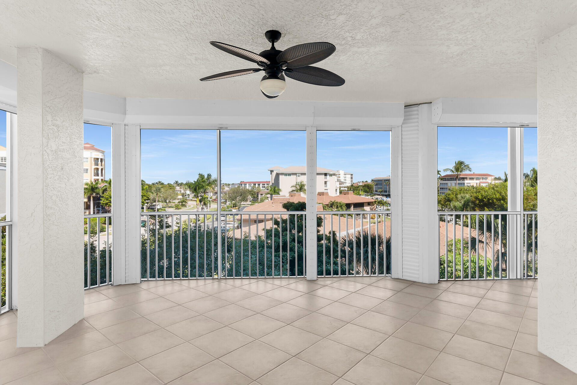 1111 Swallow Avenue, Unit 1401 Marco Island, FL 34145 - Photo 27 of 36 a view of a livingroom with a ceiling fan and wooden floor
