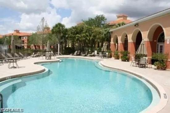 a view of a swimming pool with outdoor seating