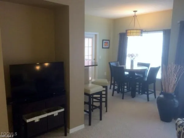 a view of a dining room with furniture and chandelier