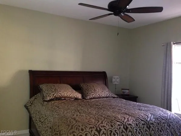 a bedroom with a bed and window