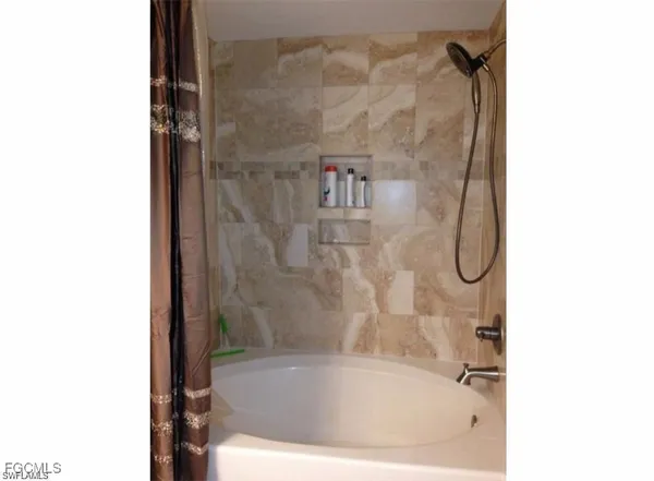 a bath tub sitting next to a white wall