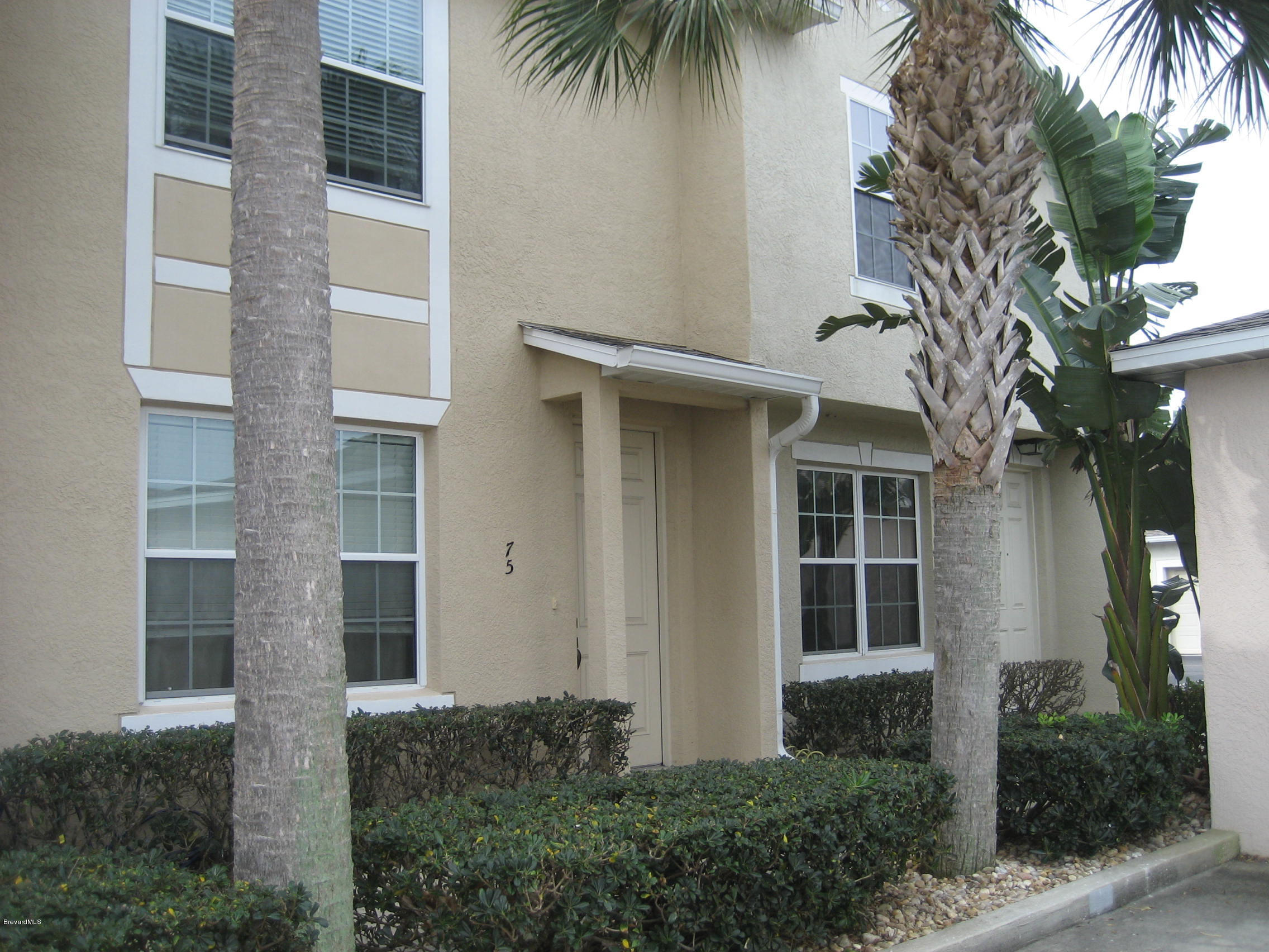85 Pinafore Place Indialantic, FL 32903 - Photo 1 of 13 a view of a house with a plants and palm trees