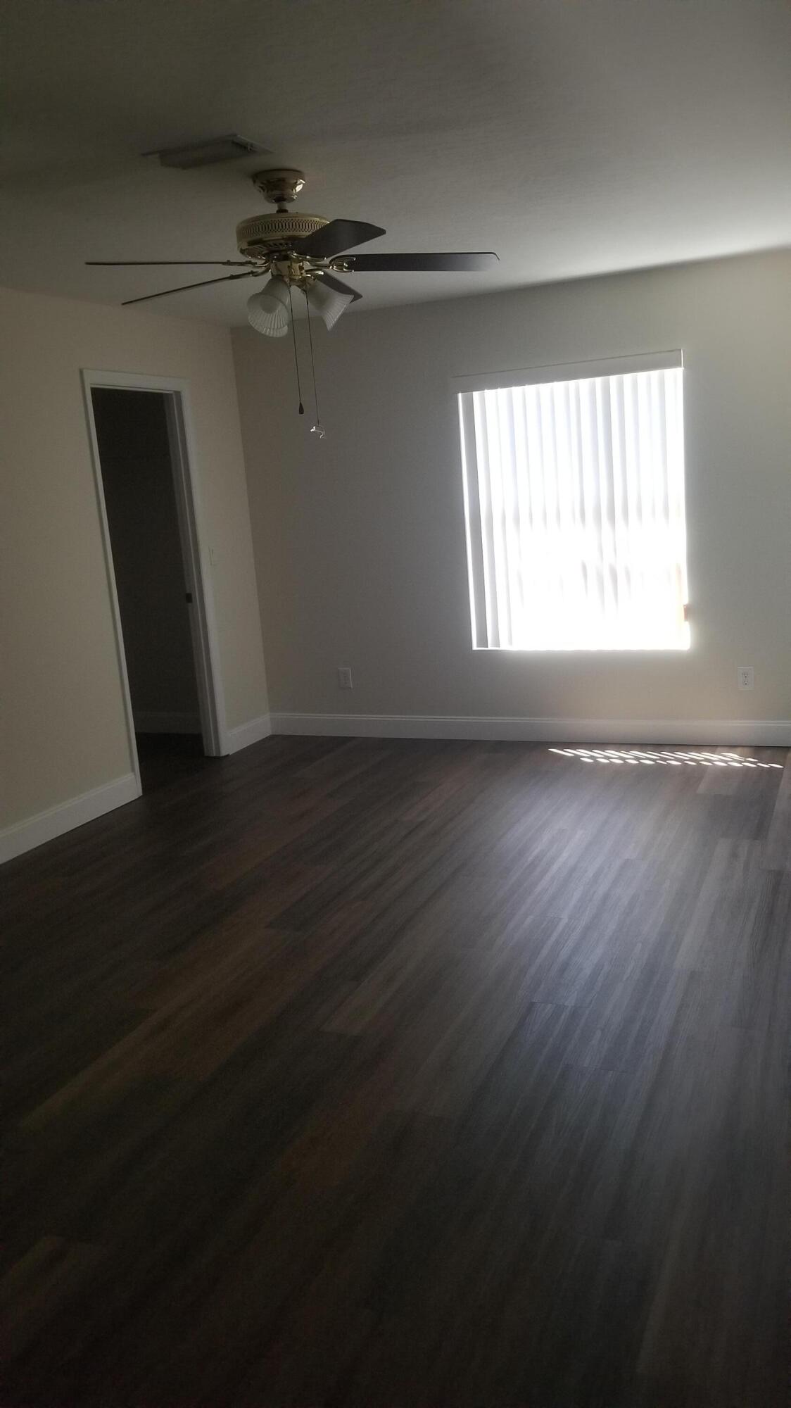 85 Pinafore Place Indialantic, FL 32903 - Photo 11 of 13 a view of an empty room with wooden floor and a window