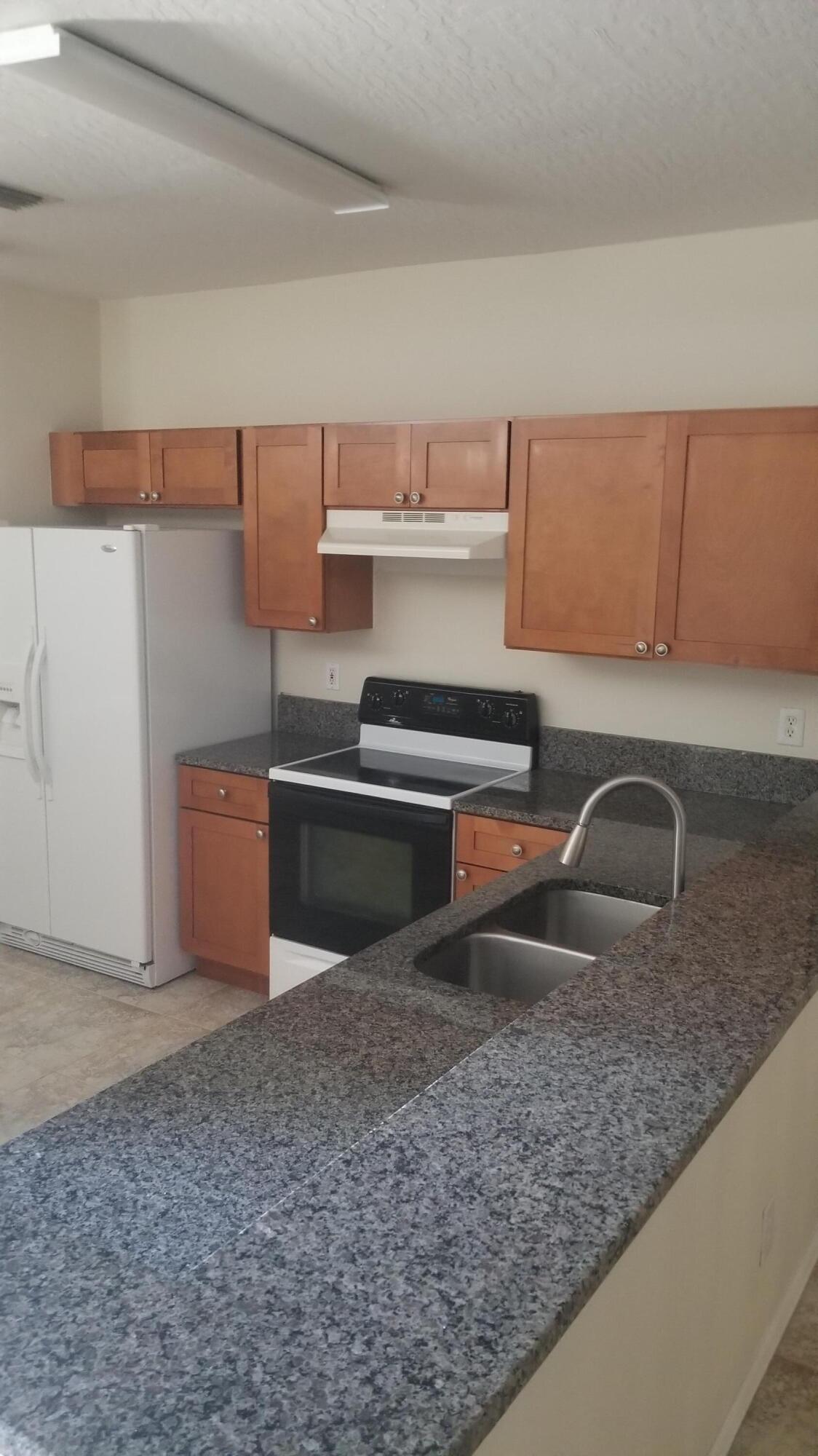 85 Pinafore Place Indialantic, FL 32903 - Photo 2 of 13 a kitchen with a sink and a refrigerator
