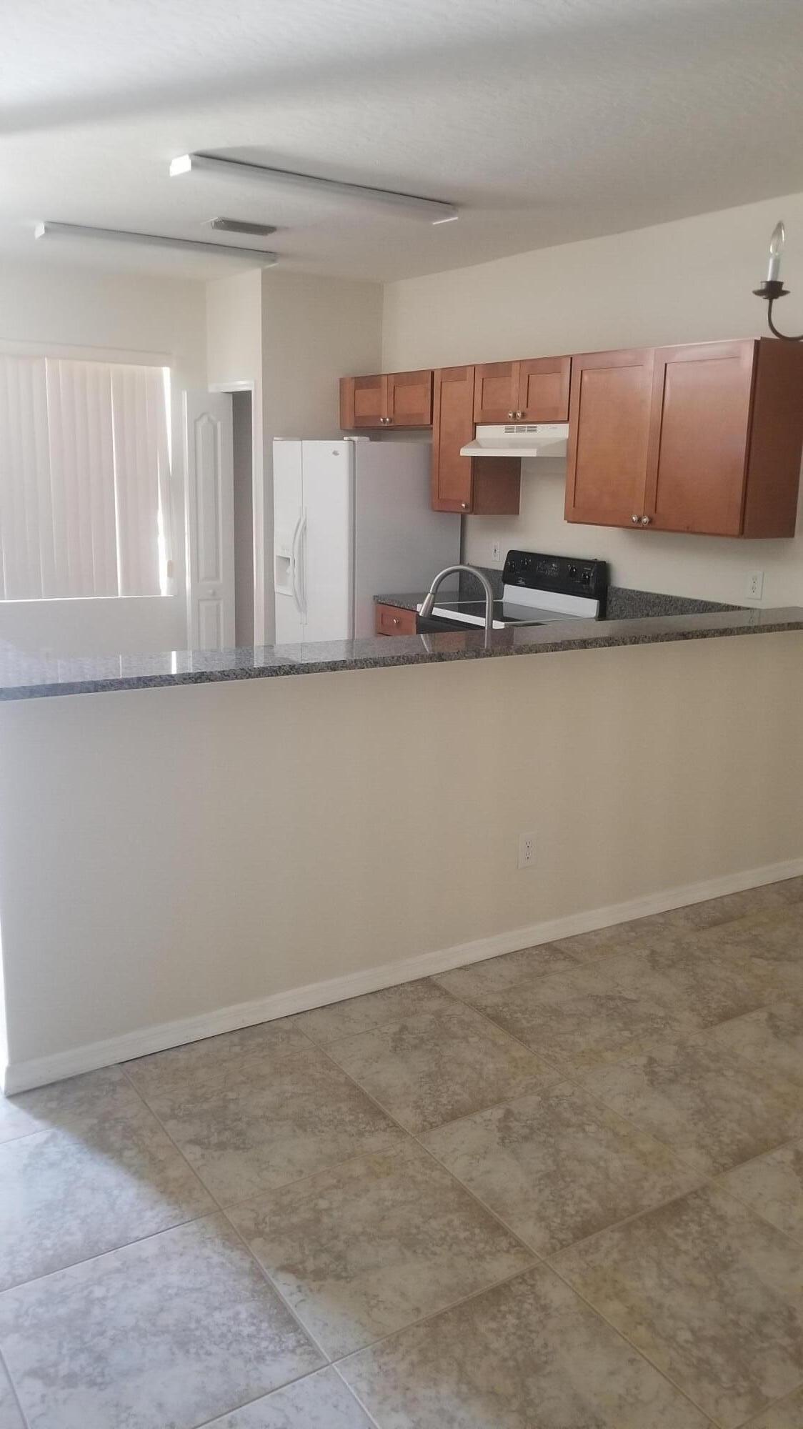 85 Pinafore Place Indialantic, FL 32903 - Photo 4 of 13 a view of kitchen with stainless steel appliances granite countertop cabinets and sink