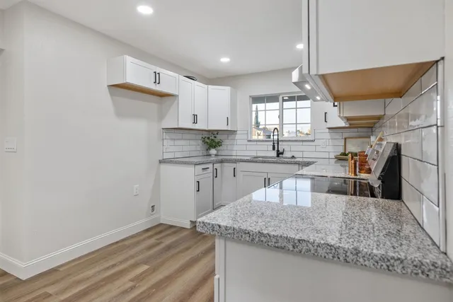 a kitchen with a sink microwave and cabinets