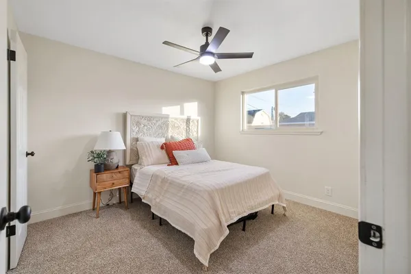 a bedroom with a bed and window