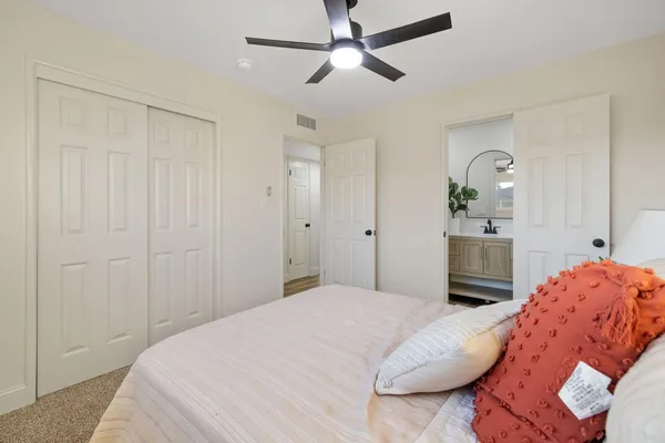 a bedroom with a bed and a chandelier