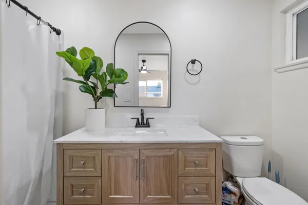 a bathroom with a toilet sink and mirror