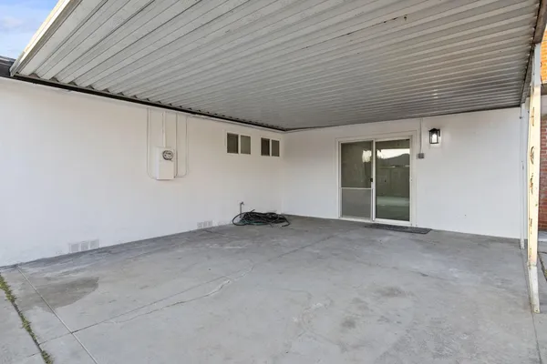 a view of a livingroom with an empty space and a window