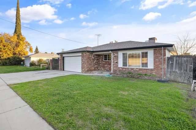 a front view of a house with plants