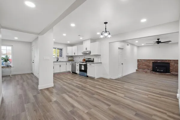 a view of a kitchen with a sink and a refrigerator