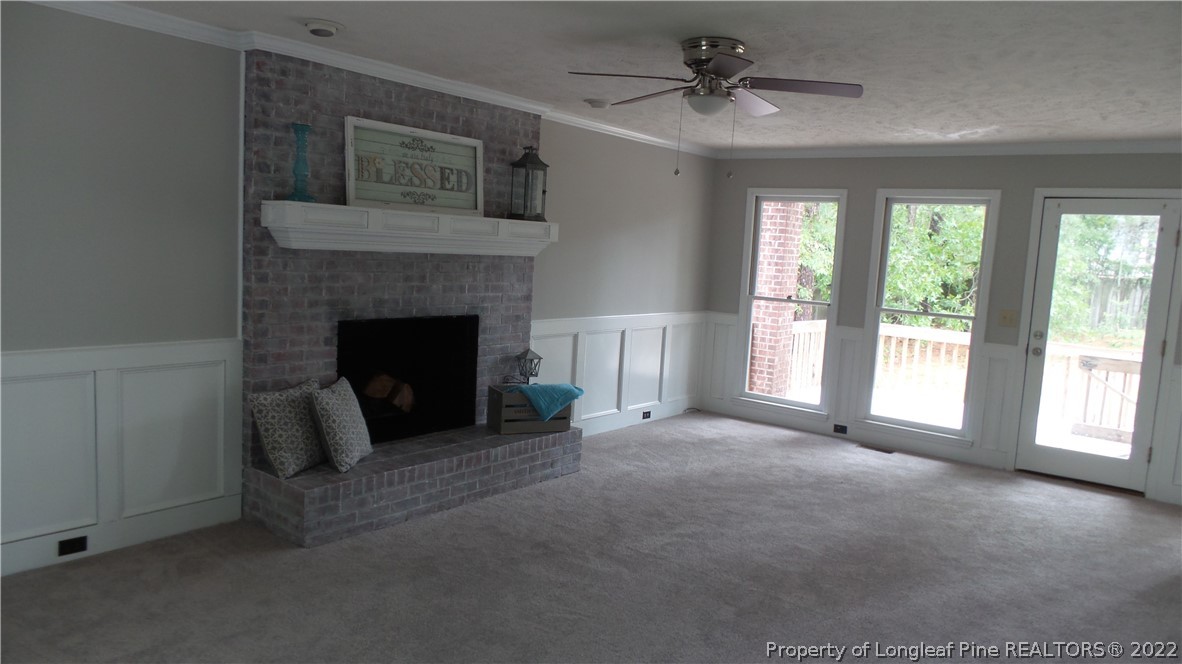 5574 Lockridge Road Fayetteville, NC 28311 - Photo 6 of 29 a living room with furniture and a fireplace