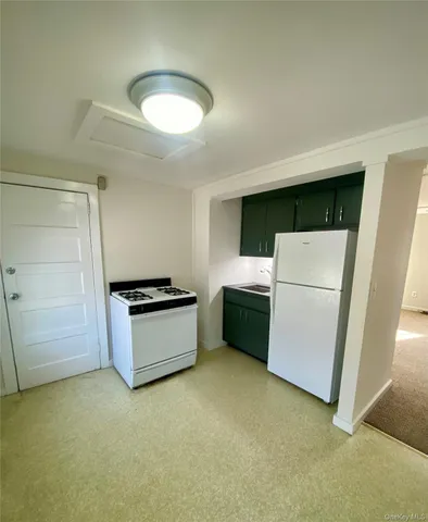 a kitchen with a refrigerator and a stove
