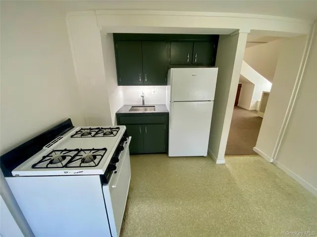 a kitchen with a stove and a refrigerator