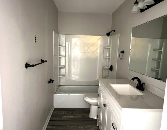 a bathroom with a sink toilet a shower and bathtub