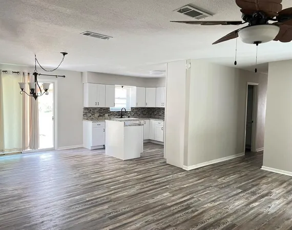a view of a kitchen with wooden floor