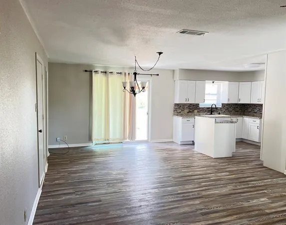 a view of a kitchen with wooden floor