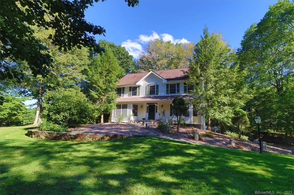 a view of a house with a backyard porch and sitting area