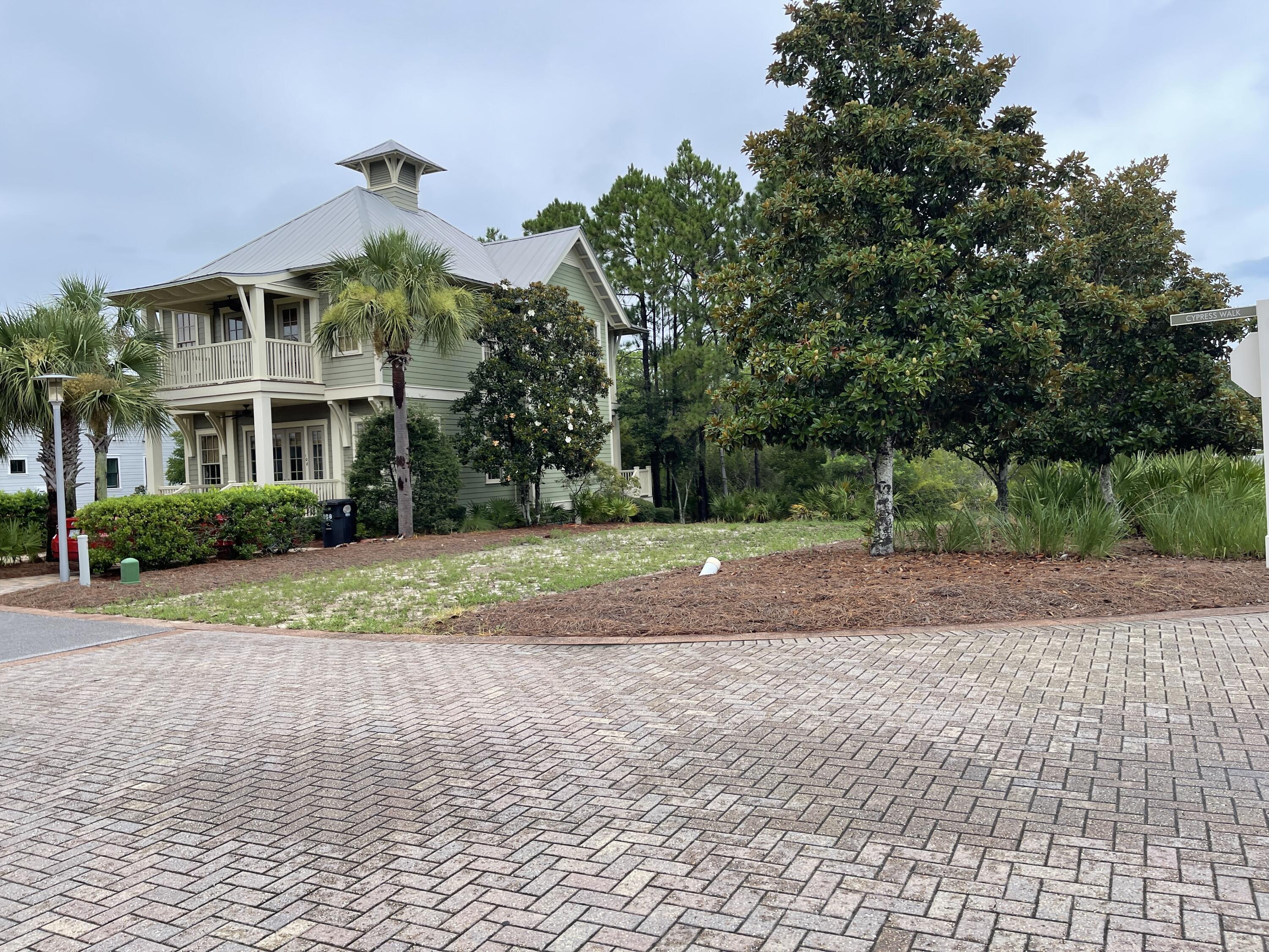 Lot 108 Cypress Walk Santa Rosa Beach, FL 32459 - Photo 13 of 17 a front view of a house with a yard and trees