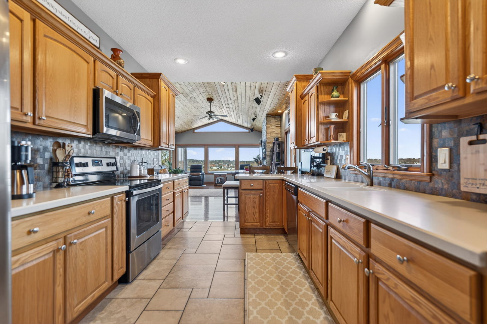 124 5th Street Fulton, IL 61252 - Photo 11 of 45 a kitchen with stainless steel appliances granite countertop a stove top oven a sink dishwasher and cabinets with wooden floor