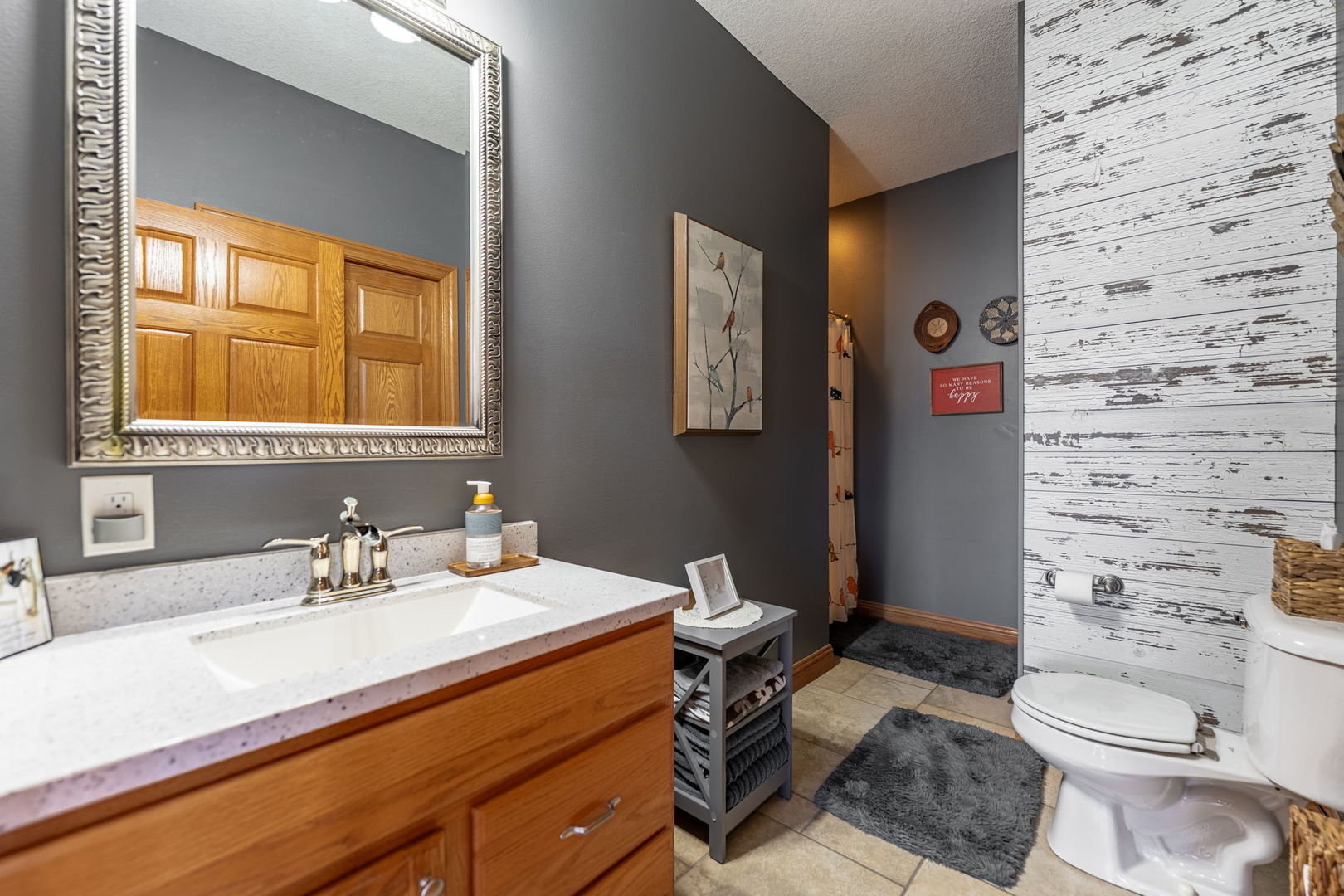 124 5th Street Fulton, IL 61252 - Photo 17 of 45 a bathroom with a sink a toilet and shower curtain
