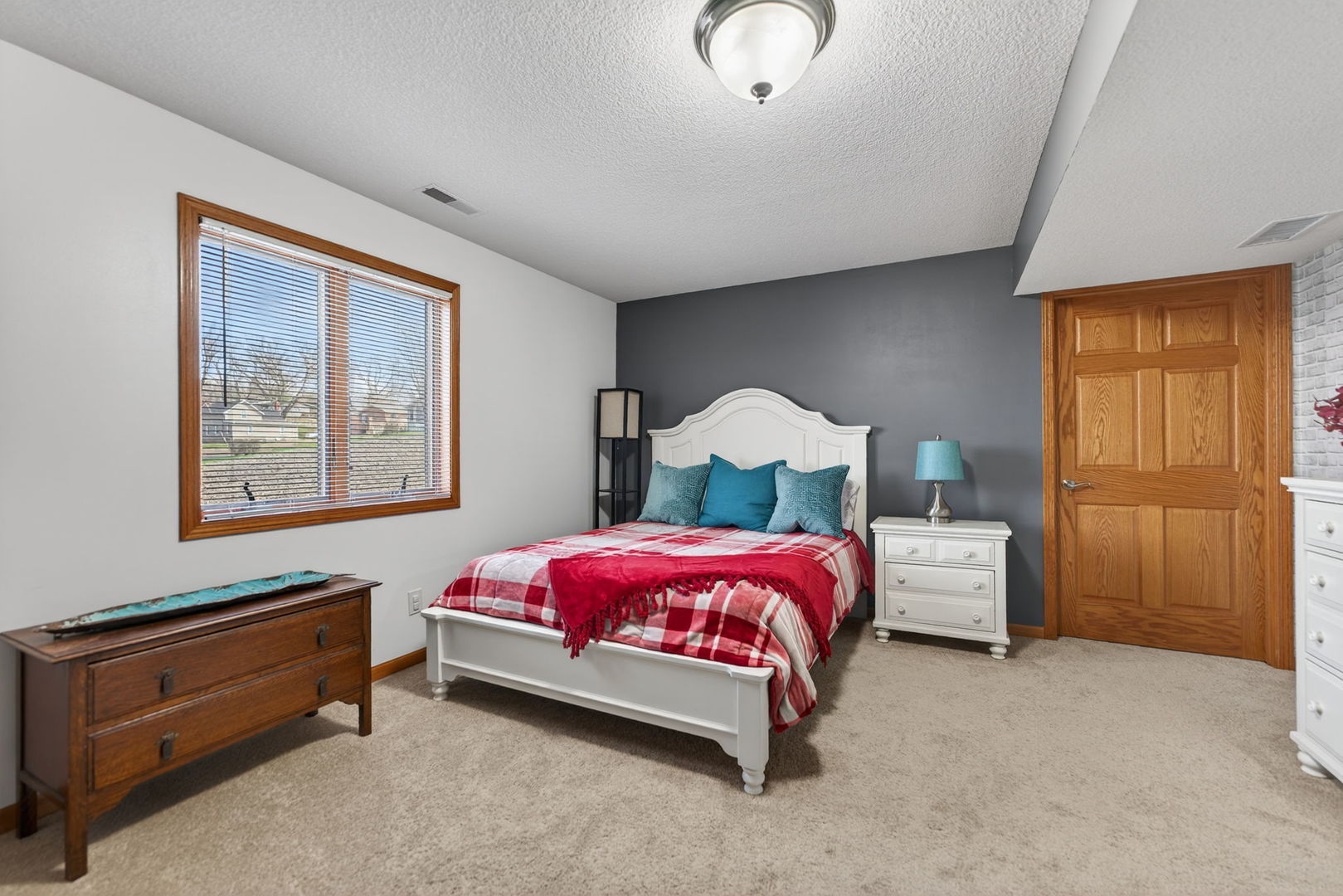 124 5th Street Fulton, IL 61252 - Photo 26 of 45 a bedroom with a bed and a chandelier
