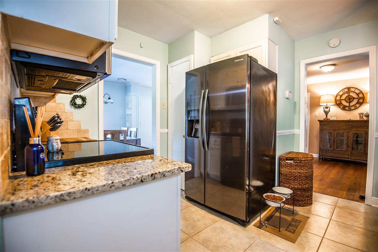 1512 Whitewater Road Memphis, TN 38117 - Photo 3 of 25 a kitchen with granite countertop a refrigerator and a stove