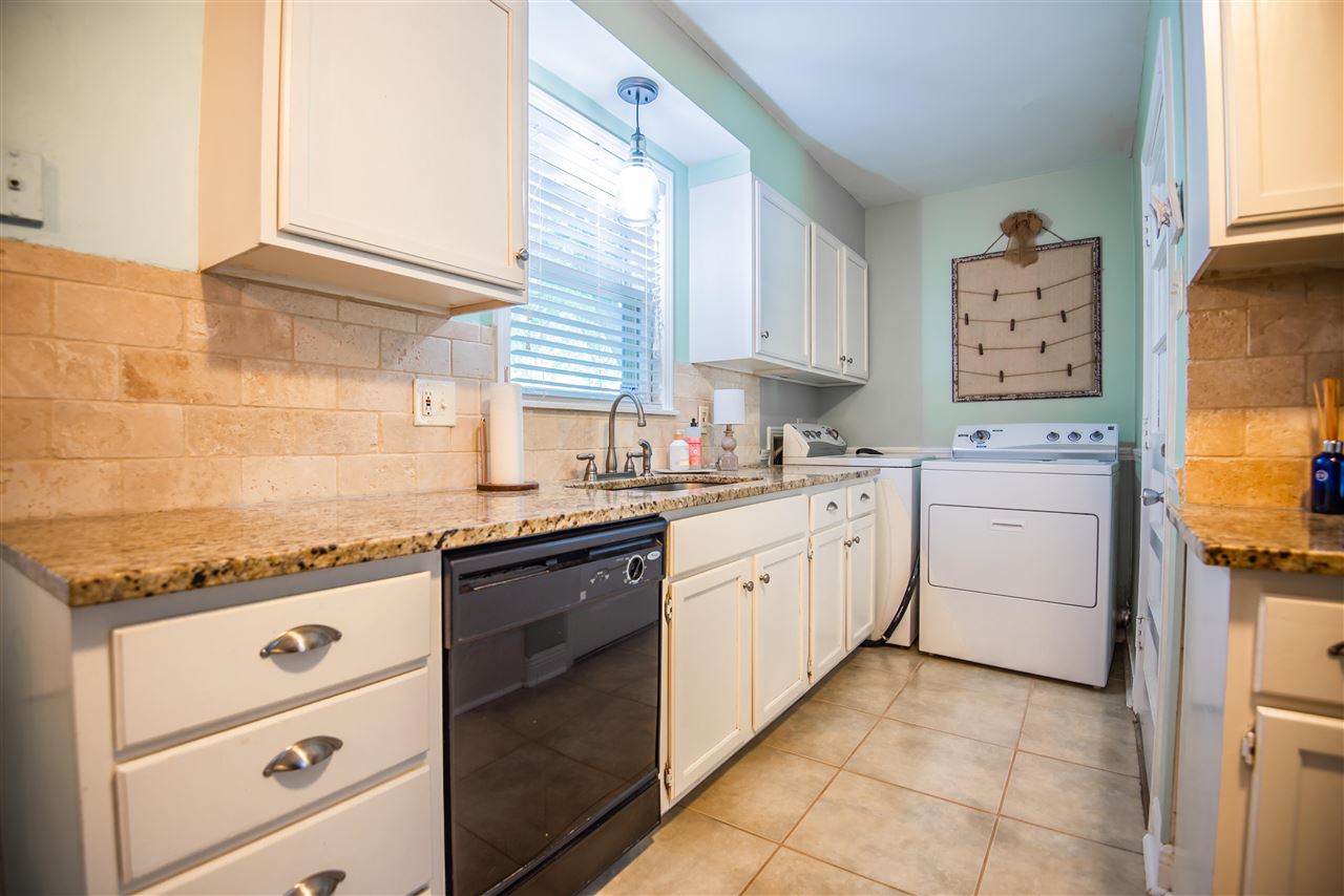 1512 Whitewater Road Memphis, TN 38117 - Photo 5 of 25 a kitchen with granite countertop cabinets and white appliances