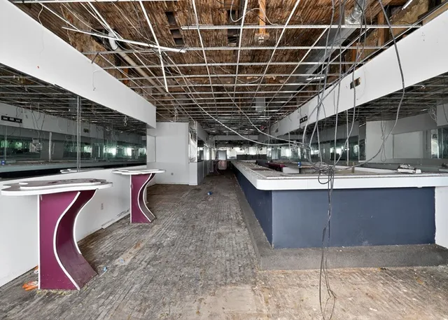 an empty room with windows and entrance