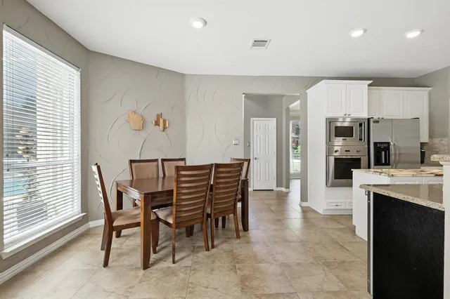 a dining room with furniture and window
