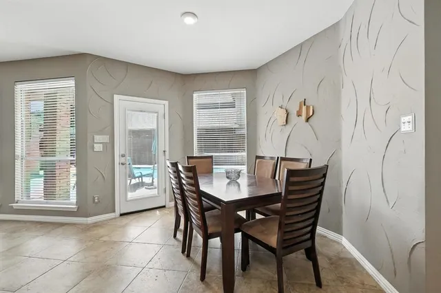 a view of a dining room with furniture and window
