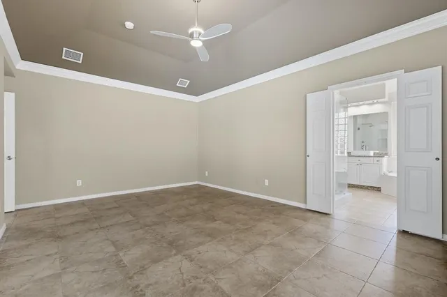 an empty room with a bathroom and a shower