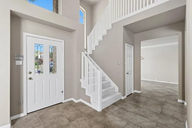 wooden floor with white walls and windows