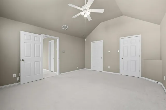 a view of an empty room with a ceiling fan