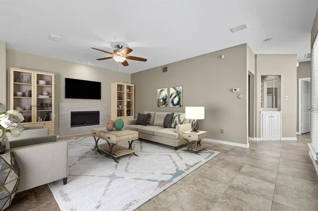 a living room with furniture a fireplace and a flat screen tv