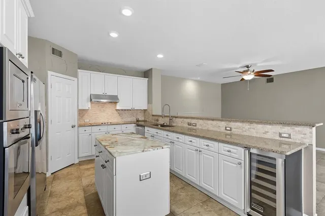 a kitchen with a sink stove and refrigerator