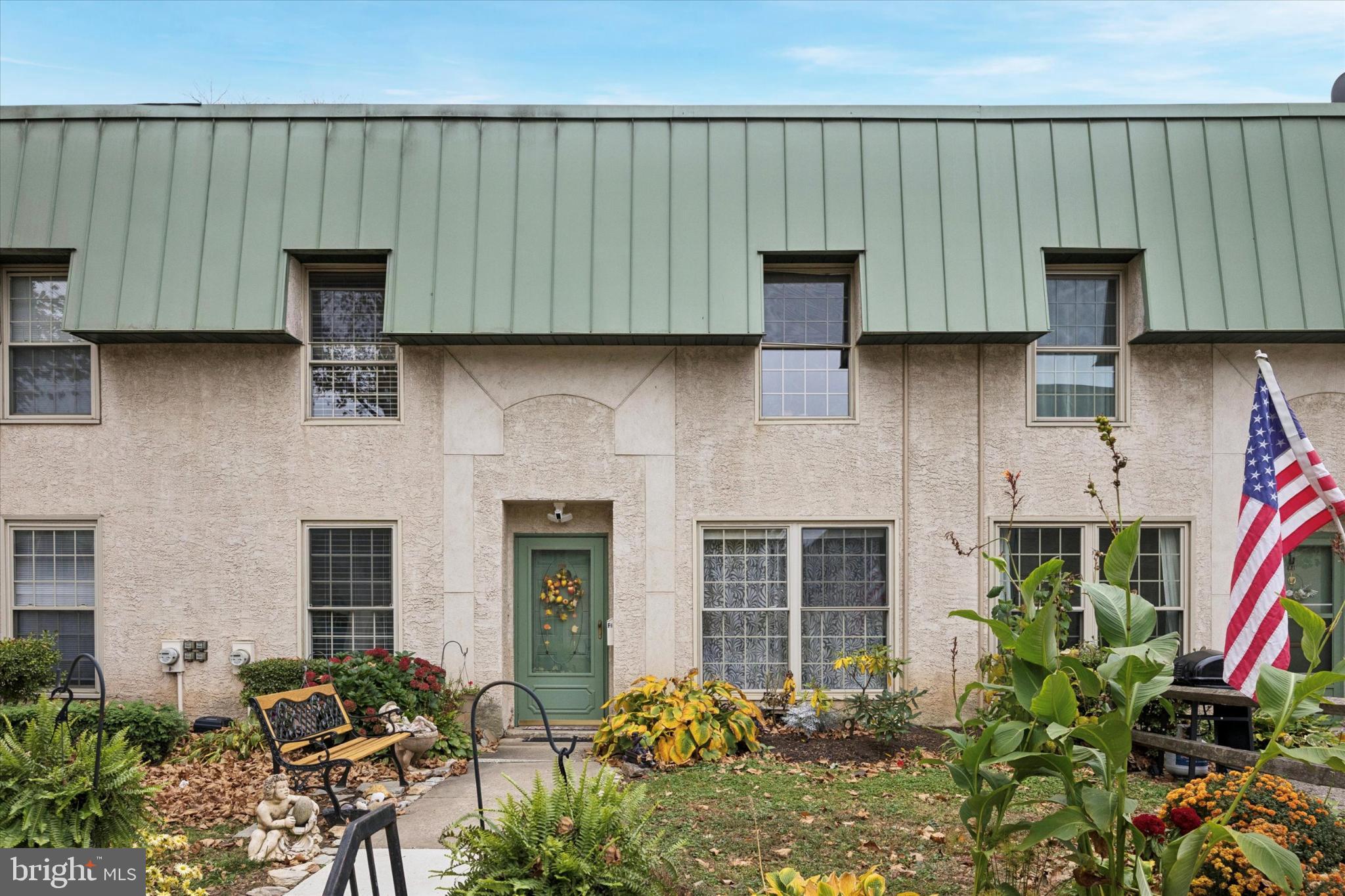 a front view of a house with potted plants