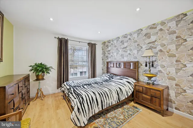 a bedroom with a bed and a potted plant