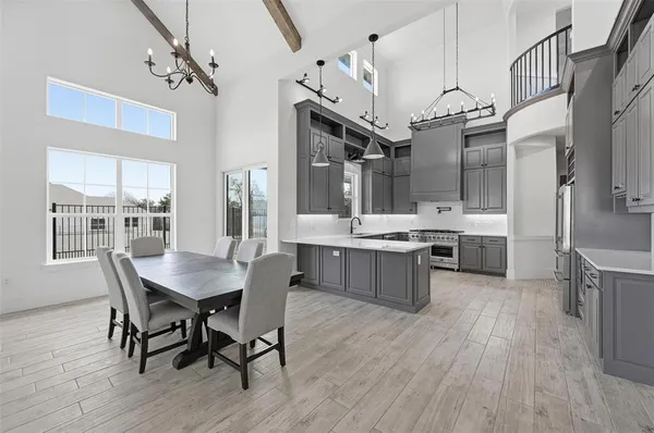 a large kitchen with a table and chairs
