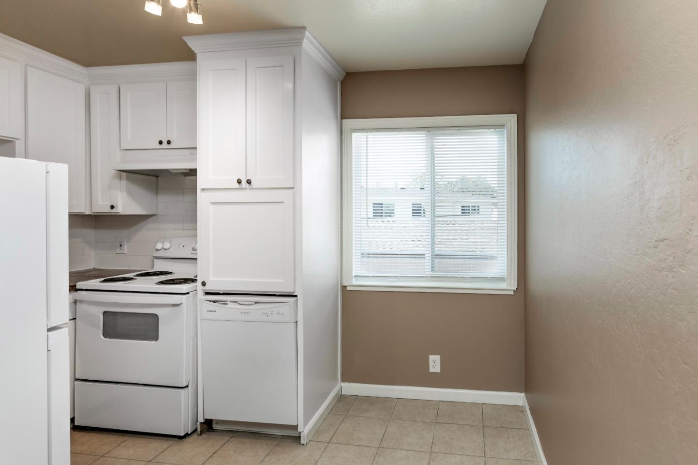 2136 Main Street Santa Clara, CA 95050 - Photo 6 of 10 a kitchen with white cabinets and white appliances