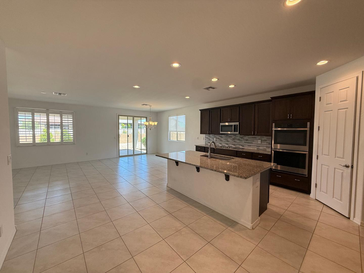 15744 West Jefferson Street Goodyear, AZ 85338 - Photo 12 of 26 a large kitchen with stainless steel appliances a large counter top and oven