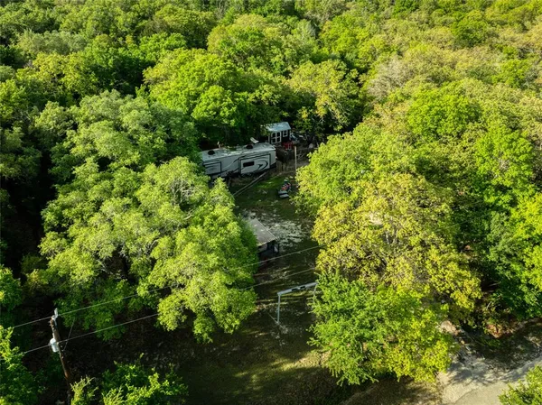 a backyard of a house with lots of green space and a fountain