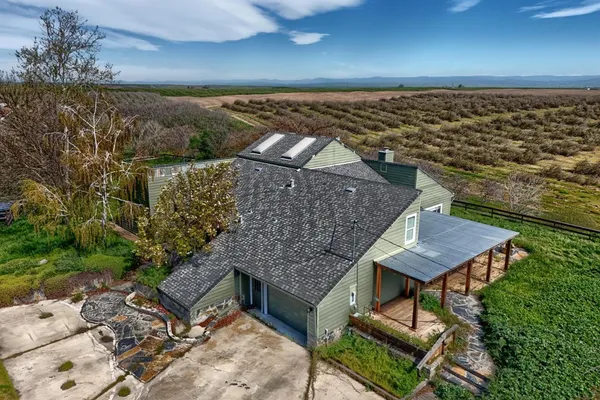 a aerial view of a house with a yard table and chairs