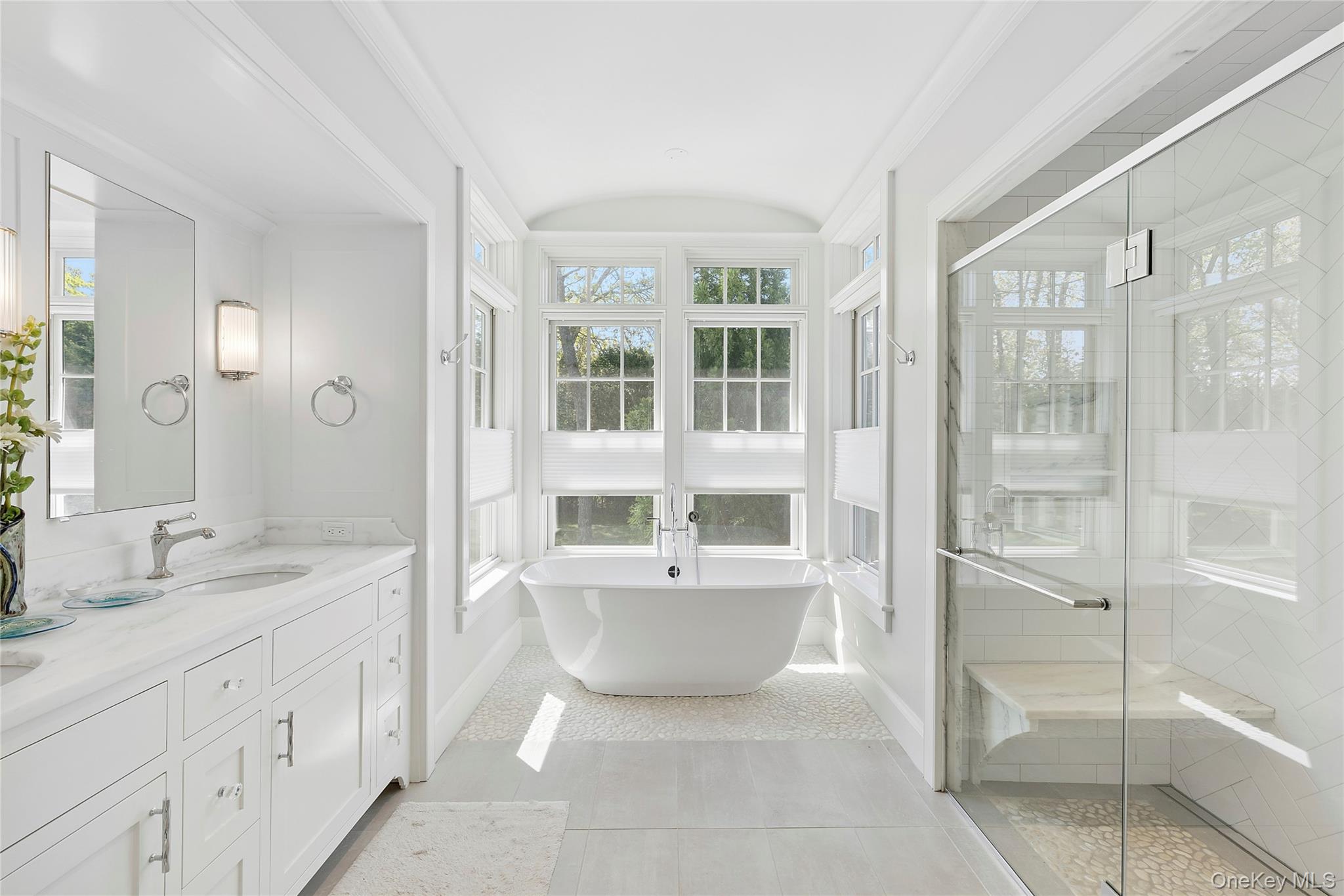 43 Old Main Road Quogue, NY 11959 - Photo 14 of 28 a spacious bathroom with a double vanity sink a mirror and a shower