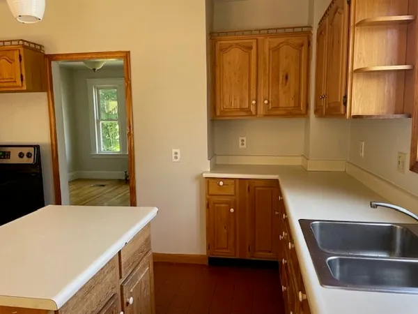 a kitchen with a refrigerator and a sink