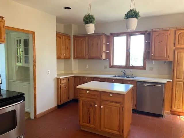 a kitchen with a sink stove and cabinets