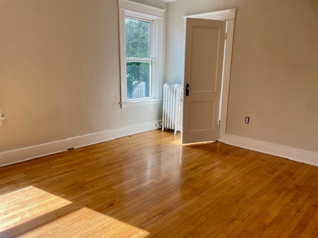 44 Boardman Street Worcester, MA 01606 - Photo 16 of 29 an empty room with wooden floor and windows